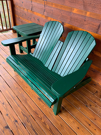 Adirondack-style bench painted green