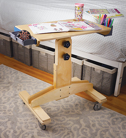 Coloring book and pencils on adjustable desktop