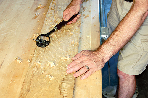 Scraping oak for calendar frame to reveal grain