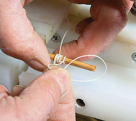 Tying kite line around bamboo strips