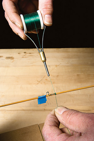 Using bobbin to start fishing rod wrap