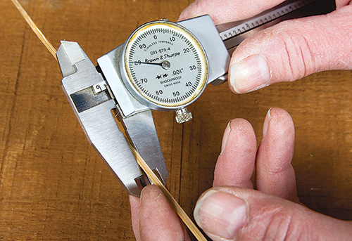 Checking measurements of bamboo pieces