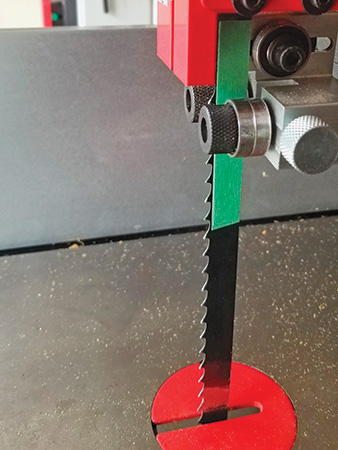 Using green paper tape as a guide for band saw and side gap