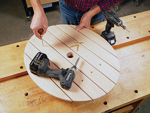 Marking screw locations for installing Adirondack table tabletop