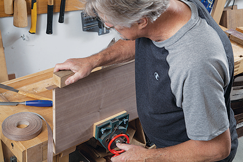 Rubbing veneer in place with a scrap woo block