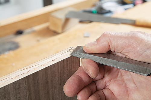 Smoothing plywood vanity edges with chisel