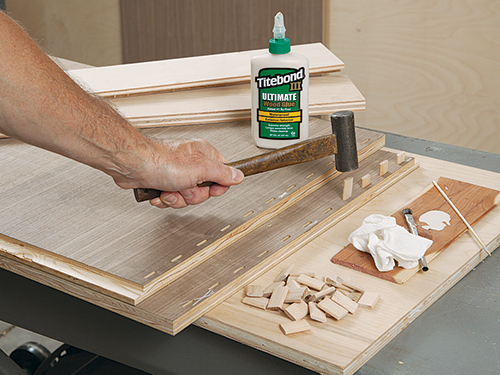 Hitting Domino dowels in place with mallet