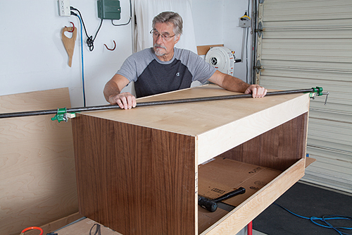 Testing squareness of vanity body with pipe clamp