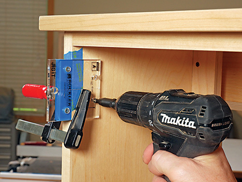 Drilling pilot holes for hinge installation in charging cabinet