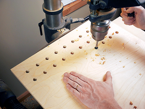Drilling router bit storage holes in drawer bottoms
