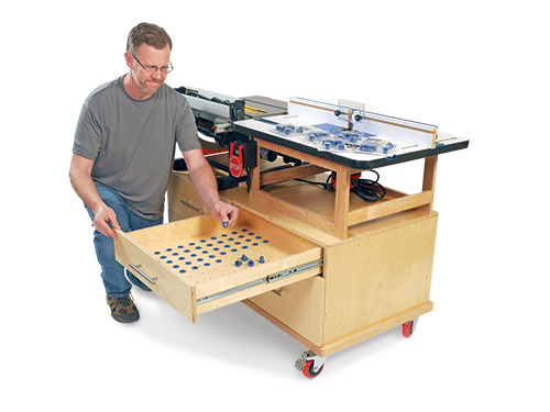 Chris Marshall placing router bits into his benchtop tool cart