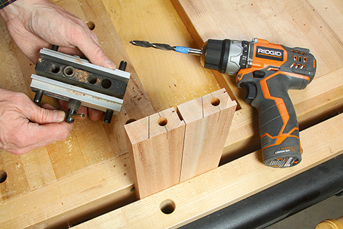 Using dowel cutting jig to make holes for tray table leg brace