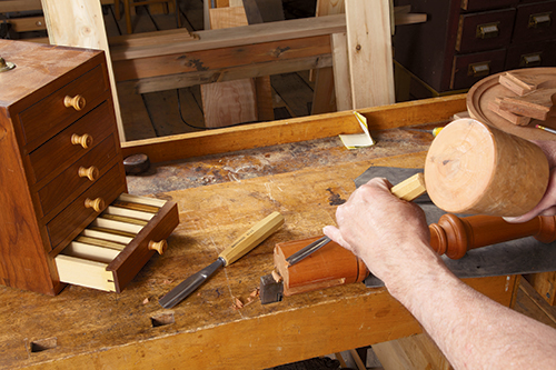 Marking center point of dovetail slot with hammer and chisel