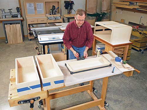 Using band clamps to secure coffee table drawer frame during glue-up