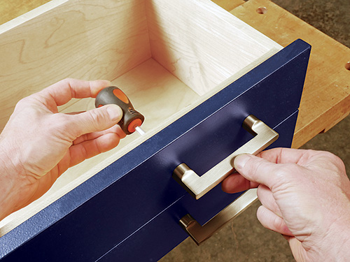 Screwing metal drawer pulls onto coffee table drawers