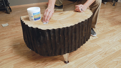 Adding pore filler to carved tabletop to smooth surface