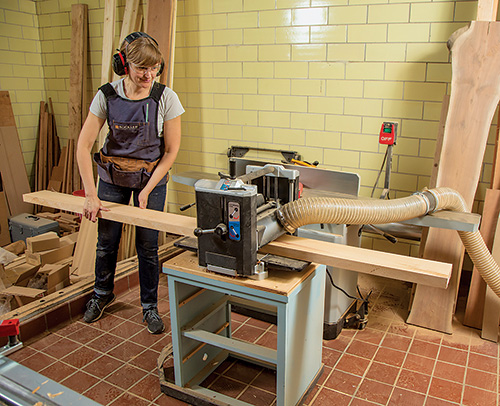 Smoothing out cedar lumber with a planer