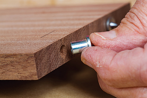 Installing metal dowels in caddy box base edge