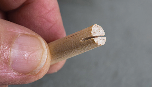 Close-up of small dowel with slot