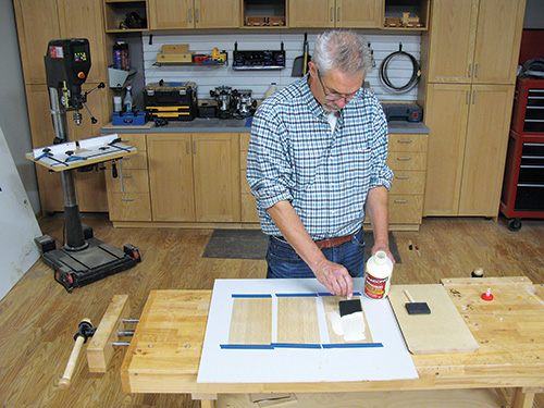 Using a foam brush to apply glue to veneer