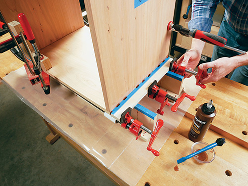 Gluing and clamping wine cabinet casework in a clamping caul