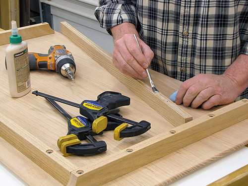 Gluing aprons to tabletop before attaching them with screws