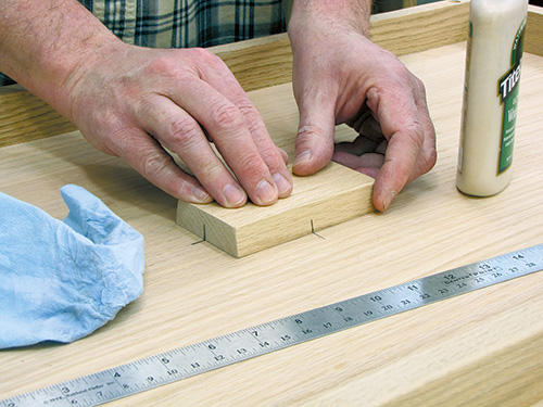 Attaching lock block to the center of underside of tabletop