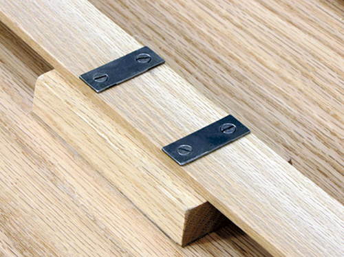 Spring locked table legs set against locking block