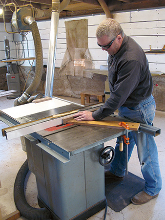 Cutting grooves in bookcase stiles with table saw and shop-made featherboard
