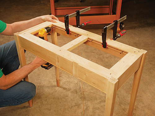 Screwing drop-leaf web frame into apron