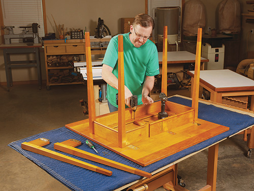 Final installation of drop-leaf table hinges on tabletop and leaf