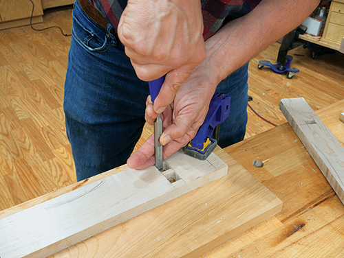 Chiseling out waste material from mortise cut