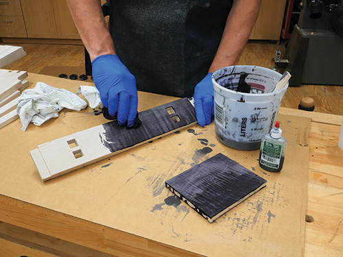 Spreading black dye across table parts