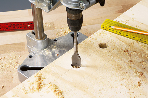 Boring holes in coffee table bed base with a drill press