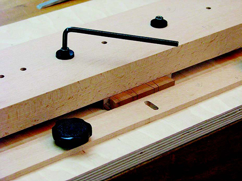 Tightening dovetailing jig over board to be cut