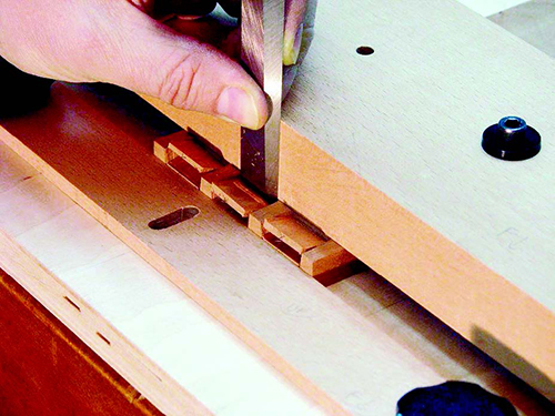 Using dovetail cutting jig stop to guid chisel cut