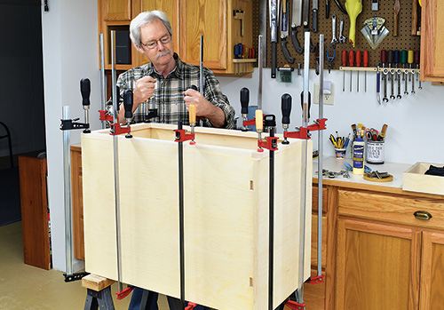 Test fitting full drill press cabinet installation
