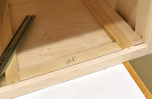 Marking drawer installation spacer on drill press cabinet