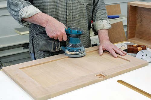 Give the completed door a good sanding, working your way up through the grits. Also, sand the center stile flush with the panels.