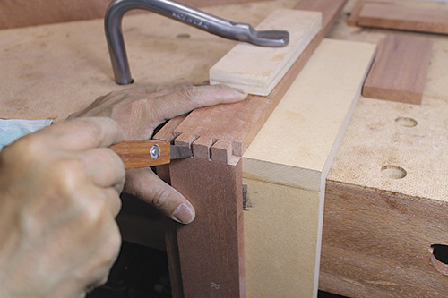 Using corner of workbench to mark out cuts on frame corner