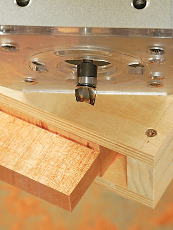 Close-up of installed piloted mortising bit and routing jig