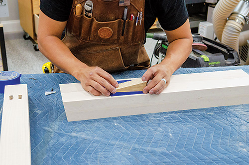 Taping clamping caul to dining table brace