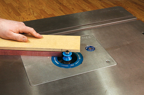 Close-up of making joinery cut with V-groove router bit
