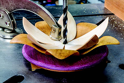 A drill press clamp prevents movement when drilling the hole for the stamens. Avoid excessive pressure or you may loosen or damage the petals.