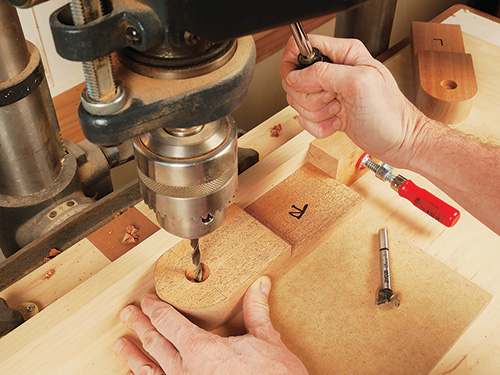 Boring bolt hole with drill press in folding adirondack chair