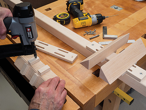 Nailing together parts of bike tire brace before attaching to rack
