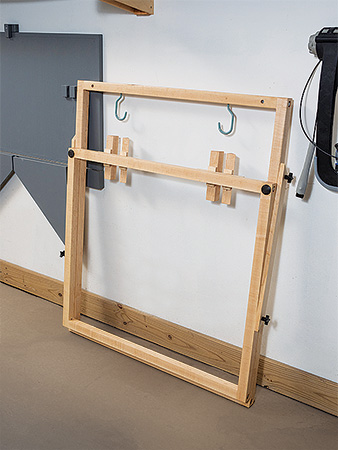 Bike rack folded up against workshop wall