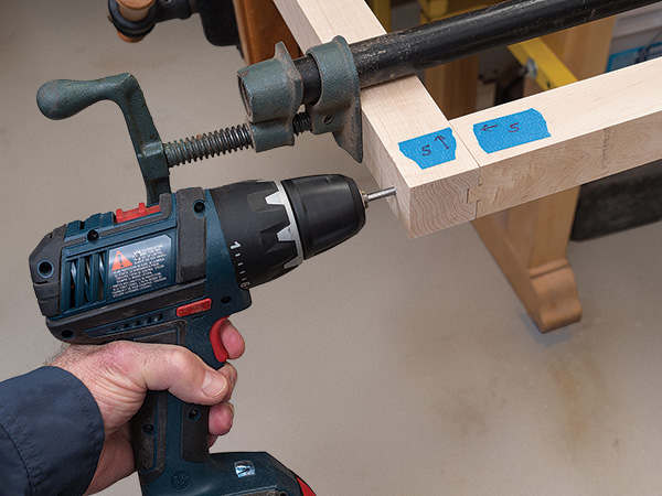 Screwing bike rack rail joinery together with drill