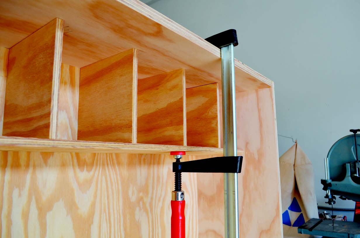 Gluing divided shelf in folding workstation cabinet