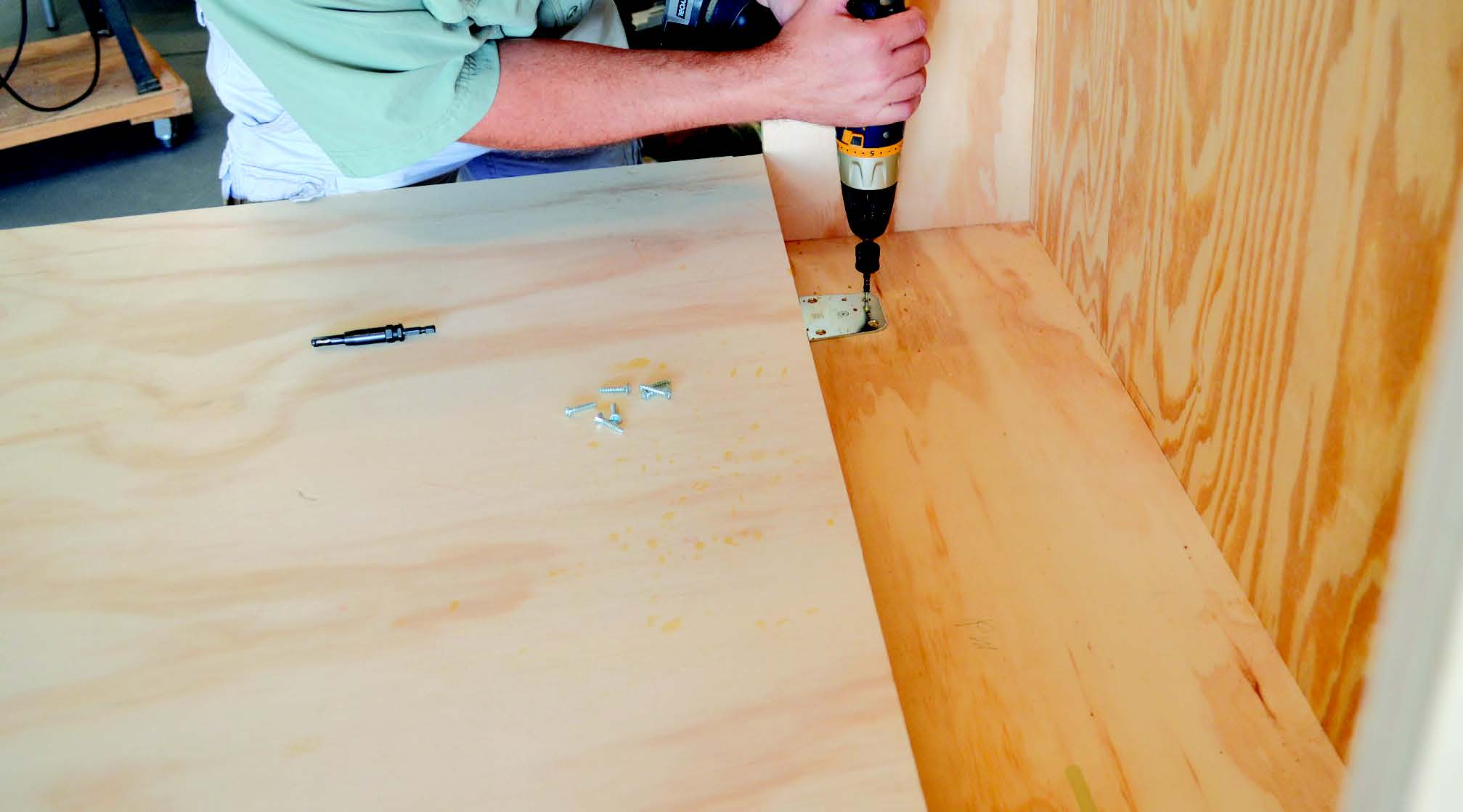 Screwing folding workstation torsion hinge in place